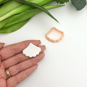 Petal scallop flower clay cutter with scalloped edge, shown with white clay piece