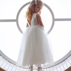White flower girl tulle dress with sleeveless bodice and layered skirt