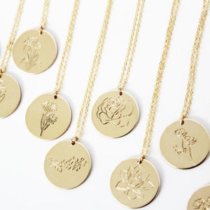 Gold birth month flower necklace with round engraved pendant discs and chain, multiple views