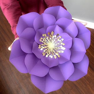 Large purple paper flower with layered petals and yellow center