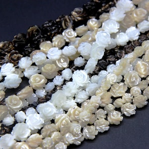 Carved mother-of-pearl flower spacer beads strand, white and cream with dark accents
