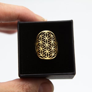 Adjustable stainless steel ring with Flower of Life geometric emblem, gold-tone finish