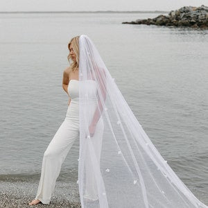 Long white bridal veil with 3D flower detail and cathedral-length drape