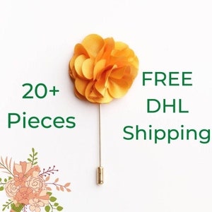 Orange fabric flower lapel pin with straight metal stick, single boutonniere pin