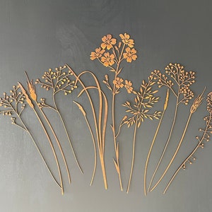 Rust orange metal wildflower plant stakes bouquet with thin stems and flower heads