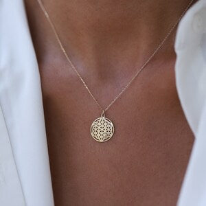 14k gold round pendant with flower-of-life pattern, on thin chain