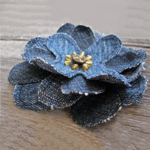 Denim fabric flower with layered petals and small gold embellishment