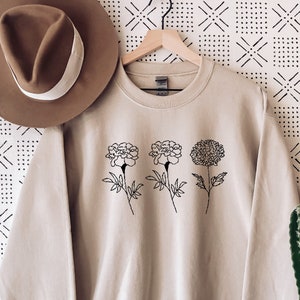 Light sweatshirt with crew neck and black floral line-art graphic on chest