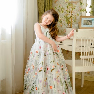 White embroidered tulle flower girl dress with sleeveless bodice and full skirt