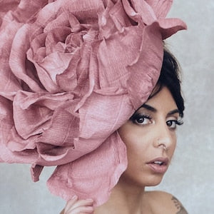 Large pink paper flower headpiece with layered petals and hair pin