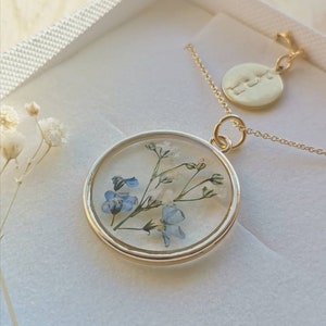 Gold flower locket necklace with blue forget-me-not blooms