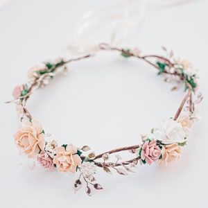 Blush and ivory flower crown headband with pale peach blooms and small green leaves
