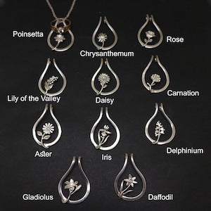 Silver birth-flower ring holder necklace with teardrop pendant and small flower charm