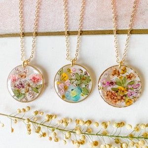 Round pressed wildflower pendant necklace on 22k gold-plated chain, colorful floral charm