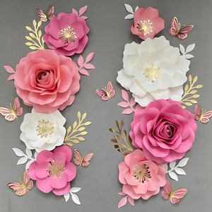 Blush pink paper flower set with white flowers, layered roses, and butterfly leaf accents