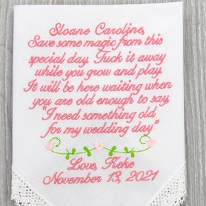 White embroidered handkerchief with pink cursive personalized wedding message and date