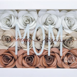 Paper flower shadow box frame with rose flowers in white, beige, and 'MOM' lettering