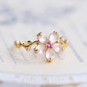 Rose gold-tone flower ring with pink rose quartz crystal petals and small clear accents