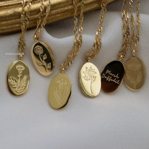 Gold-tone birth flower necklace with multiple engraved floral pendants on chain