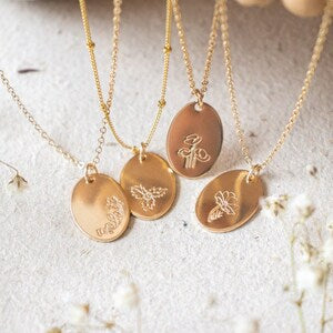 Gold birth flower necklace with round engraved pendants and fine chain