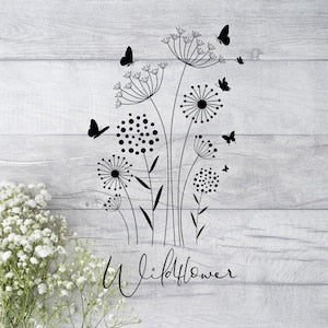 Wildflower graphic shirt with dandelion-style flowers, black butterflies, and cursive 'wildflower'