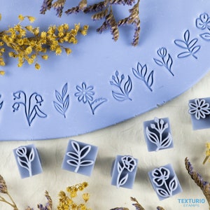 Floral polymer clay embossing stamps, blue blocks with flower and leaf designs