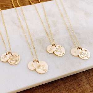 Round gold-tone floral initial necklace pendants on thin chain, set of multiple