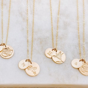 Gold-tone chain necklace with round pendant stamped floral and birth-flower initial