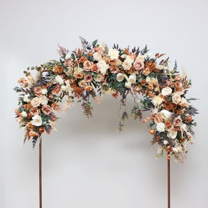 Floral arch arrangement with orange, cream and white flowers and greenery