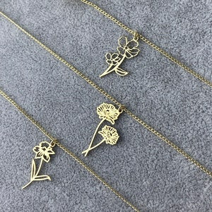 Gold-tone dainty birth flower pendant necklaces with small floral charm and leaf details