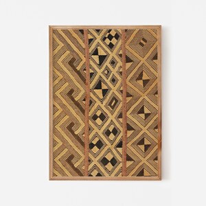 Framed tribal textile wall art print with geometric patterns in tan, brown, and black