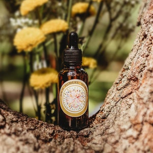 Amber glass dropper bottle of Bach Flowers custom blend with floral label
