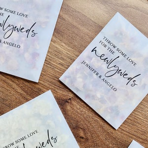 Personalised biodegradable confetti packets with printed wedding message on white paper
