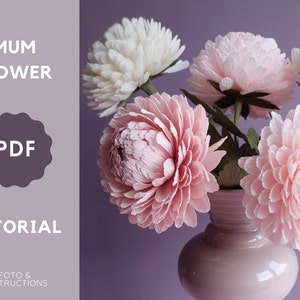 Crepe paper chrysanthemum flowers in vase, soft pink and white blooms with layered petals