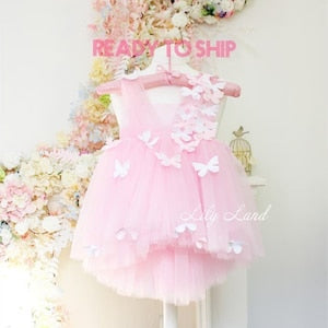 Light pink tulle first-birthday dress with layered skirt and butterfly applique