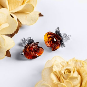 Sterling silver rose earrings with dark amber flower centerpiece, stud style