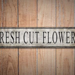 Vintage-style metal sign reading “Fresh Cut Flowers”
