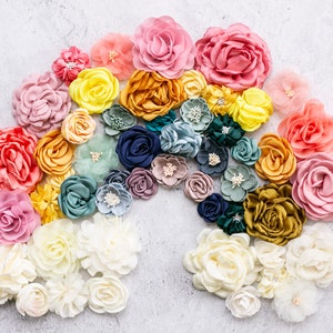 Assorted multicolor fabric rosette flowers: pink, yellow, blue, green, cream