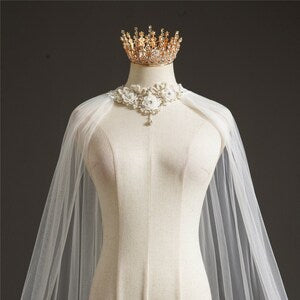 Bridal shoulder veil in ivory tulle with lace floral neck clasp and long drape
