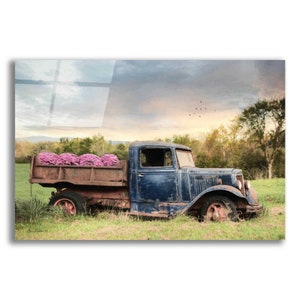 Acrylic glass wall art of a vintage blue truck carrying pink flowers