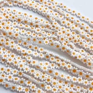 Handmade millefiori glass flower beads, white with yellow centers, flat round strand