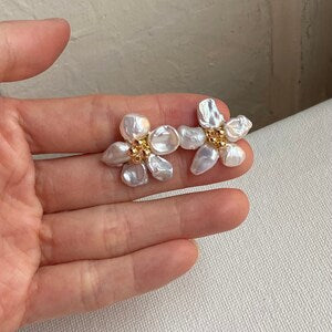 Small white flower pearl stud earrings with clustered petal design