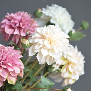 Artificial faux dahlia flowers in dust pink and ivory with green leaves