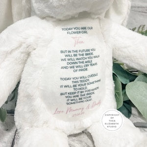 White plush teddy bear with embroidered thank-you message on its back