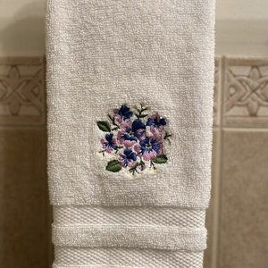 White embroidered hand towel with blue and purple spring flower motif
