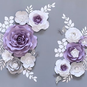 Lilac and white paper flower wall decor set with layered rose-style blooms and leaves