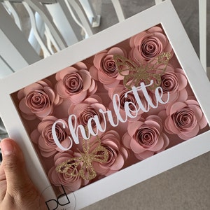 Paper flower shadow box with pink rose paper flowers and 'Celebrate' lettering