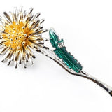 Dandelion flower brooch with gold tone petals and emerald green leaf details