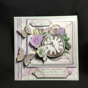 Vintage style greeting card with 3D clock face and purple and green flowers