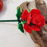 Red and green novelty brick rose decoration with attached leaves